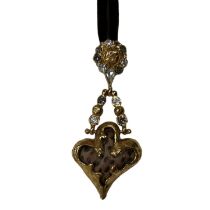 A vintage Christian Lacroix abstract heart shaped pendent in a textured gold tone metal. The heart