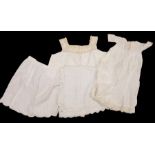 A box of white wear containing: a maid's apron/overall dating from Edwardian era up to the 1930s;