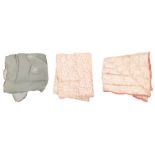 A collection of quilted eiderdowns to include: a pink paisley design on a cream background, c.1930s;