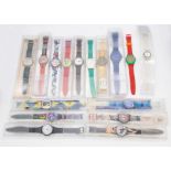 A collection of sixteen cased Swatch watches, along with another without case, various designs,