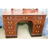 A late 20th Century desk of small proportions in mahogany, with issues