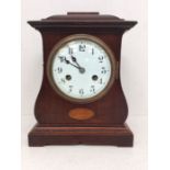 Edwardian mahogany 8-day mantel clock with Arabic numerals and shell inlay detail.