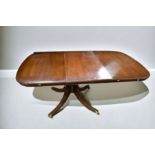 A repro D Ended dining table in mahogany, with a single extension leaf