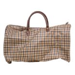 An Aquascutum weekend bag in traditional Aquascutum print in coated canvas with leather trim,
