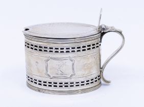 A George III silver oval mustard pot and cover, bright cut and pierced decoration, shaped