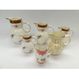 A collection of four graduating in size Coalport "The Caughley Mask-Head Jugs", along with two