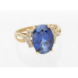 A synthetic sapphire and diamond 9ct dress ring, claw set oval and sapphire,  approx 13 x 9mm, to