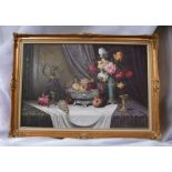 A large gilt framed still life oil on canvas of fruit and flowers by Bela Balogh, signed lower