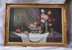 A large gilt framed still life oil on canvas of fruit and flowers by Bela Balogh, signed lower