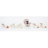 A collection of 19th century Staffordshire figures of sheep and cows together with one of a shepherd