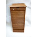 A tambour-fronted lockable filing cabinet with nine internal drawers along with a small mid 20th