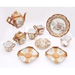 A Japanese Meji period red ground and gilt detailed porcelain part tea set, consisting of tea pot