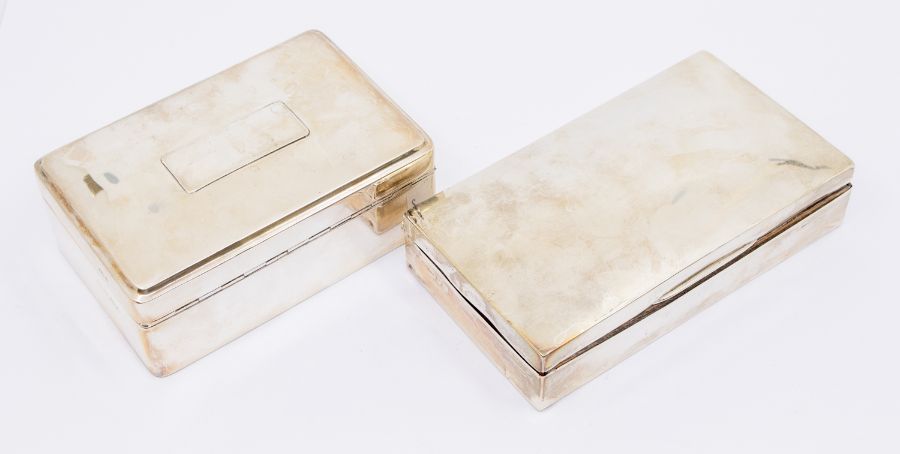 Two early 20th Century silver cigarette boxes, both with fitted interiors, one hallmarked