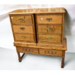 A mid 20th century solid oak bookcase with inlay to the top, two single drawers and two bookshelves,