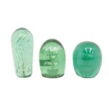 A collection of three Victorian green "End of Day" glass paperweights/dumps, all floral designed