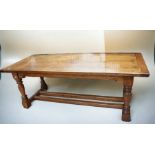 A large reproduction solid oak refectory table in 17th century style with turned legs and double