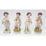 Four similar Staffordshire figures of Cherub like children, two perching, the other two carrying