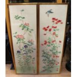 A pair of decorative Chinese silk screens depicting various flowers, one with bird above, both