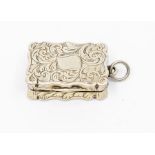 A Victorian silver vinaigrette, wavey sides with engraved foliate decoration, gilt pierced and