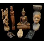 A collection of 20th Century carved wooden Eastern or African items to include; a large Buddha