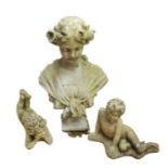 A collection of three 20th Century patinated stone figural statues, two of laying children, the