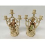 Pair of early to mid 20th C continental candle sticks porcelain with figures below three candle