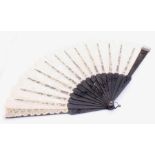 An intricately carved mid 19th Century Irish Bog Oak and lace folding fan, with harp, clover and