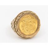 A Victorian half Sovereign ring within a pierced fancy 9ct gold ring mount, size Q, total gross