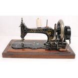 A late 19th century Frister & Rossmann of London shuttle sewing machine in a mahogany and walnut