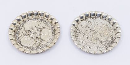A pair of Victorian Aesthetic silver circular pin trays, lobed sides, with varied floral decoration,