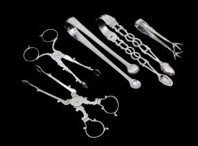 A collection of five silver sugar/tea tongs to include; A 19th Century pair with acorn and