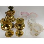 A collection of 20th century brass oil/paraffin lamps, with glass shades and tubes for centre. (1