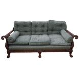 A bergere three-seater sofa, having ornate carved detail of eagle-headed arms, and foliate detail,