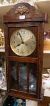 German wall clock with 2 train movement striking on a gong. Silvered dial with Arabic numerals.