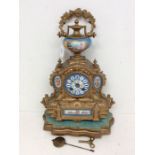 A late 19th century gilt spelter French mantel clock with Parisian porcelain face, finial and