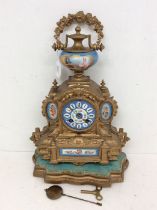 A late 19th century gilt spelter French mantel clock with Parisian porcelain face, finial and