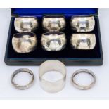 A matched set of six Edwardian napkin rings, engraved decoration and navette shaped cartouche with