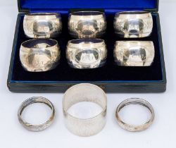 A matched set of six Edwardian napkin rings, engraved decoration and navette shaped cartouche with