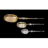A collection of three silver anointing spoons to include; One larger silver gilt example, hallmarked