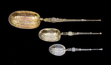 A collection of three silver anointing spoons to include; One larger silver gilt example, hallmarked