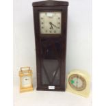 1930s' oak wall clock, ivory-coloured Bakelite mantel clock, and a carriage clock.