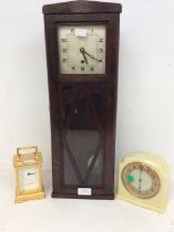 1930s' oak wall clock, ivory-coloured Bakelite mantel clock, and a carriage clock.