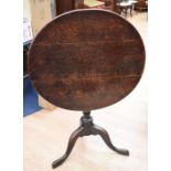 Two 18th Century oak tilt top tables with tripod legs and plank tops