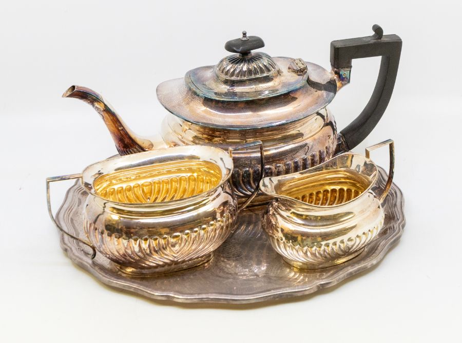 Early 20th century silver plated three piece tea set with plated tray, gilt to insides.