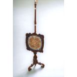 A 20th Century fire screen with embroidered detail to detachable top (missing holding screw)