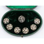 An Edwardian set of five silver buttons, each with foliate decoration, hallmarked by Samuel Jacob,