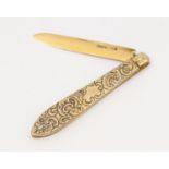 A late Victorian silver gilt fruit knife, the handle engraved with trailing fruit and foliage,