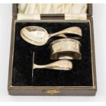 A George VI plain silver christening set including spoon, pusher and napkin ring, hallmarked by Adie