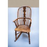 Stained pine kitchen spindle back rocking armchair with stretcher