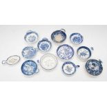 A collection of various blue and white ceramic tea strainers to include; a small oval spoon